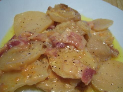 "Cheesy Garlic Scalloped Potatoes - Creamy potato casserole topped with golden cheese."