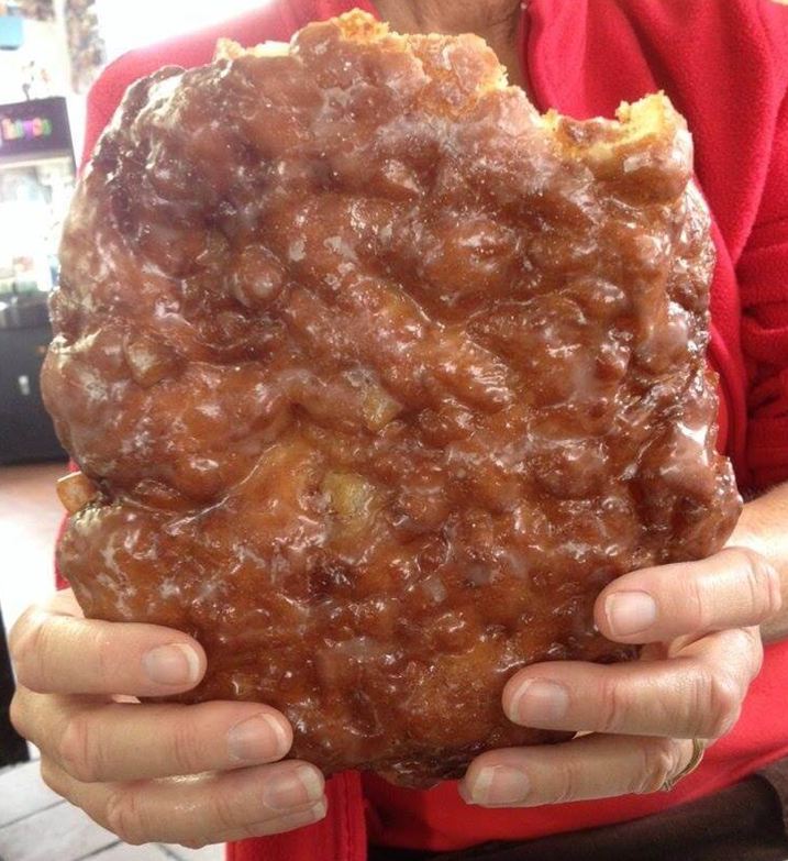 Close-up of a freshly cooked Big Apple Fritter on a plate.