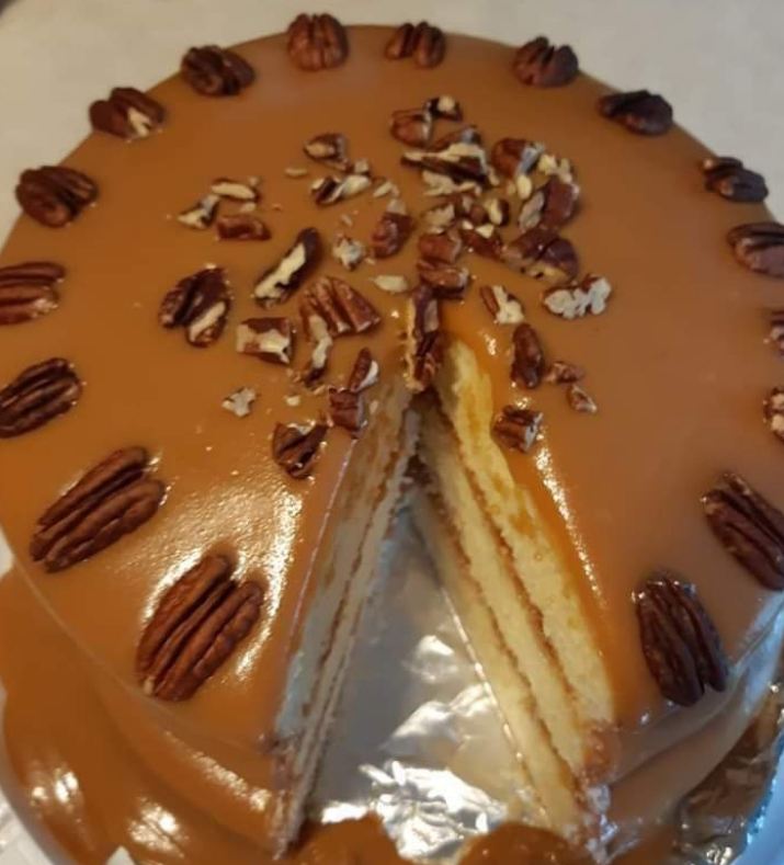 Slice of old-fashioned caramel cake with Georgia pecans on a plate