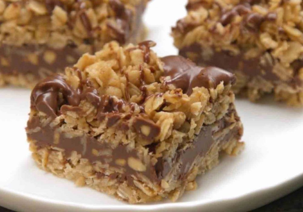 A tray of no-bake chocolate oat bars on a white background.