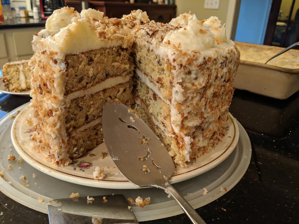 Italian Cream Cheese Birthday Cake - Layers of moist cake with cream cheese frosting, garnished with chopped pecans