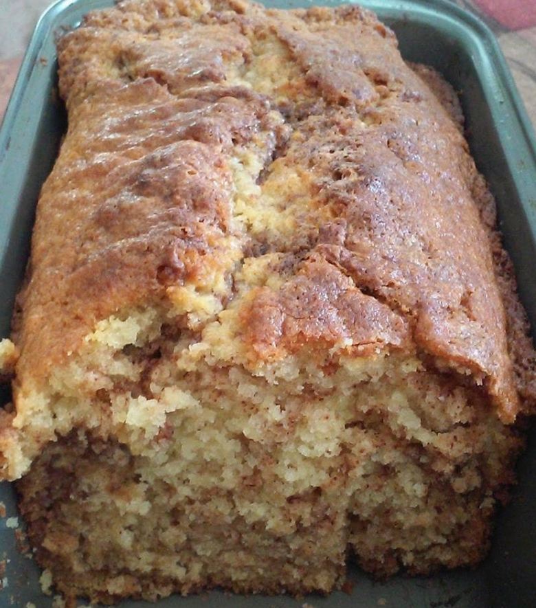 Freshly baked Amish Cinnamon Bread with a sprinkling of cinnamon on top.