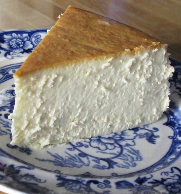 A delectable New York Cheesecake with a golden crust and creamy interior.