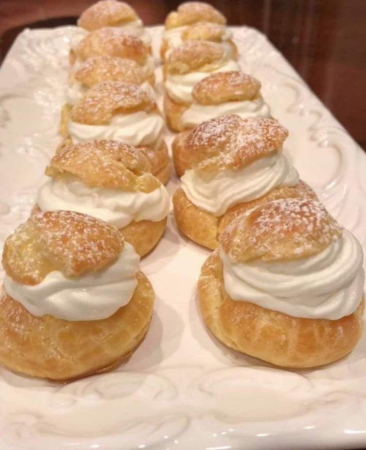 "Cream Puffs with Whipped Cream and Chocolate Drizzle"