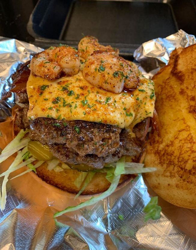 A close up photo of a Cajun Shrimp Burger on a grill pan