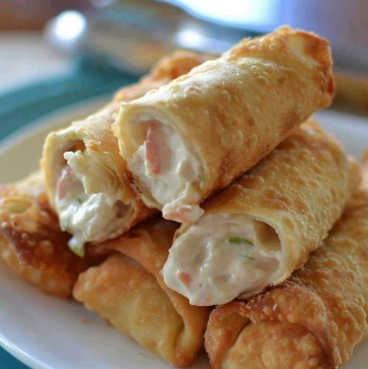 Crispy Crab Rangoon Egg Rolls filled with fresh crab, cream cheese, and spices – a golden delight for your taste buds.