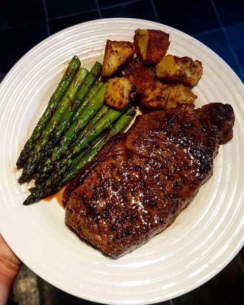 "Succulent sirloin steak, butter-basted to perfection, accompanied by crispy roast potatoes and oven-roasted asparagus—a culinary masterpiece."