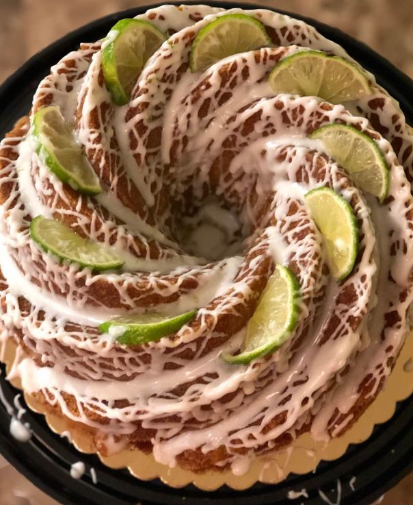 A slice of key lime pound cake with a key lime cream cheese glaze on top.