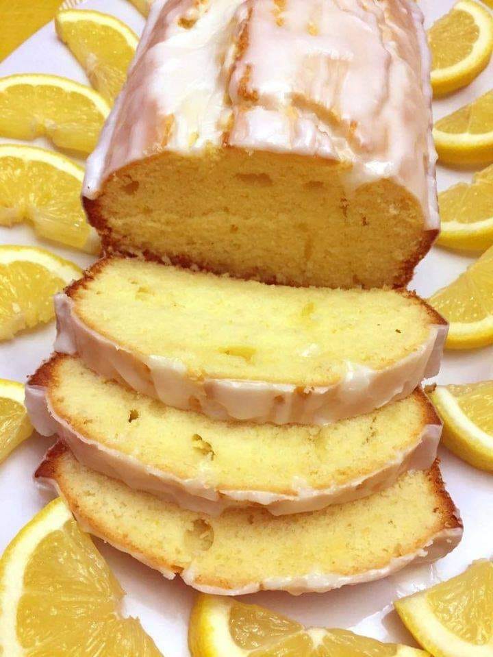 A slice of Lemon Loaf with a moist texture, tangy lemon flavor and sweet lemon glaze on top