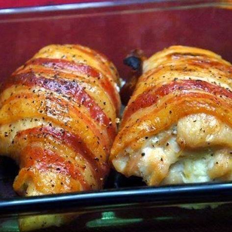 A plate of bacon wrapped cream cheese stuffed chicken breast with roasted vegetables.