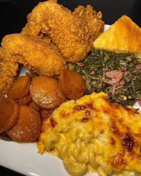 Golden brown fried chicken with a crispy crust Cheesy and creamy mac and cheese Candied yams with a caramelized glaze