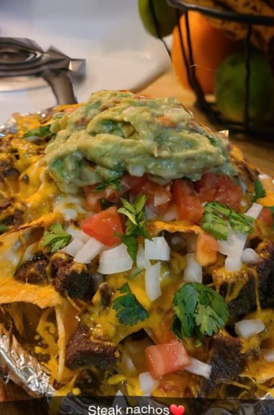 "Sizzling Steak Nachos with Melted Cheddar and Fresh Toppings"