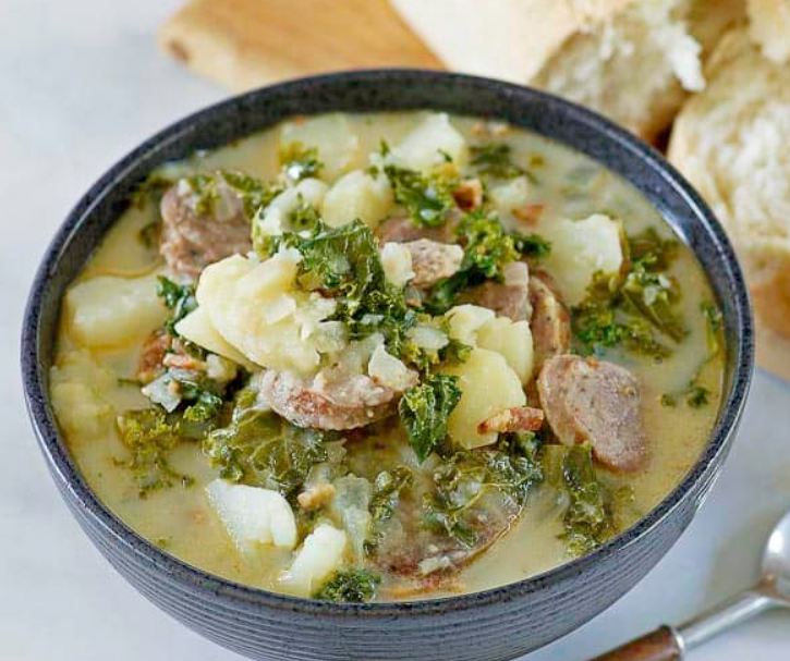 "Delicious Olive Garden Zuppa Toscana Soup in a rustic pot, showcasing the perfect blend of Italian sausage, bacon, potatoes, kale, and creamy goodness."