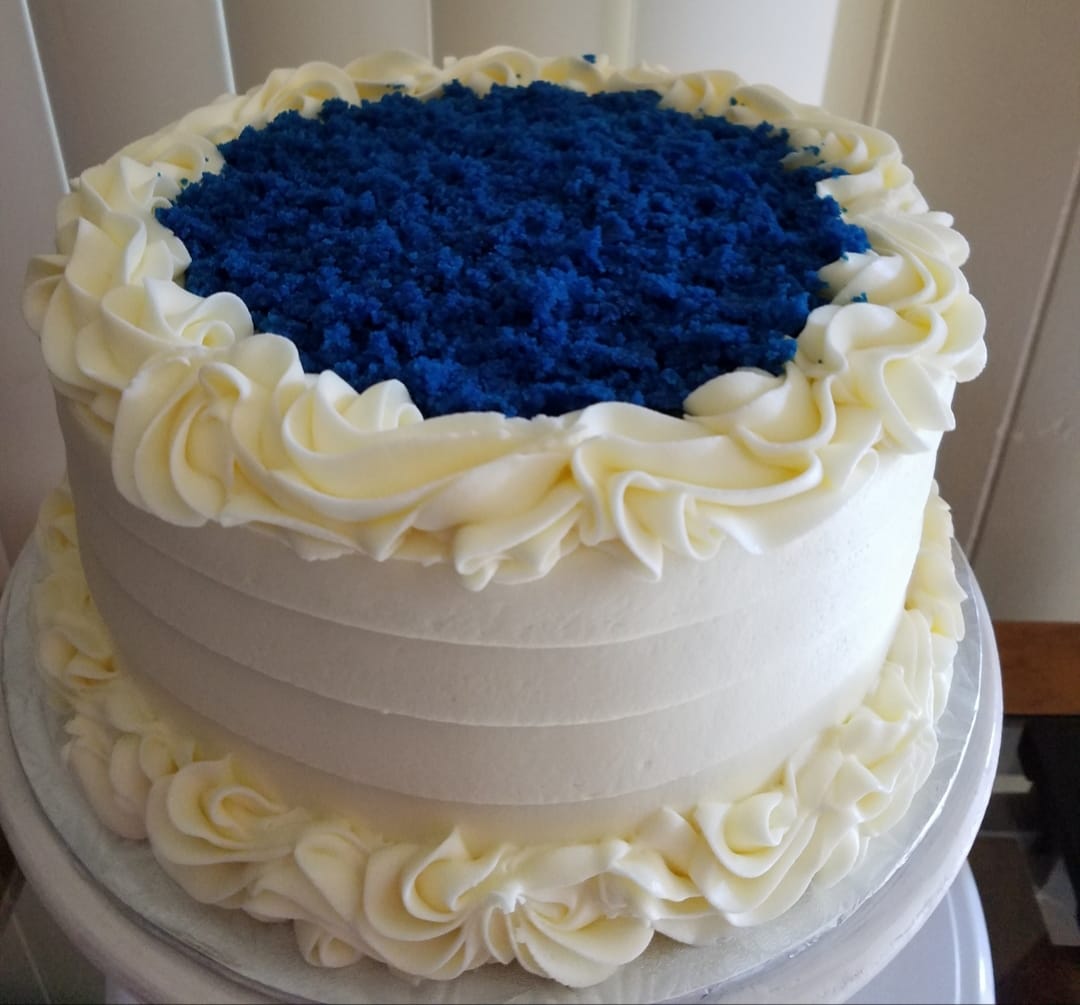 Blue Velvet cake with cream cheese frosting on a white plate