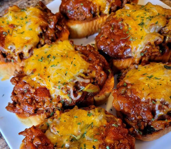 Homemade Sloppy Joes: A tempting sandwich topped with melted mozzarella, crafted with lean ground beef and flavorful spaghetti sauce.