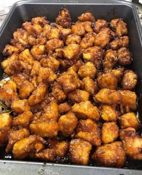 Baked Sweet and Sour Chicken - Crispy chicken pieces coated in a flavorful sauce, served with rice