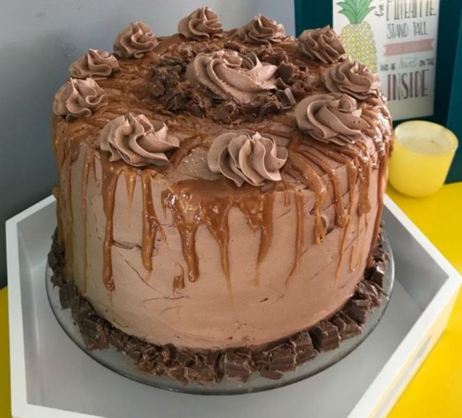 A beautifully sliced piece of Salted Caramel Chocolate Layer Cake, revealing the layers of chocolate and caramel