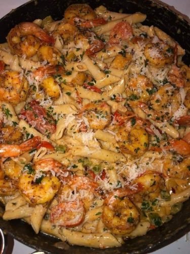 A plate of creamy Cajun shrimp pasta, with juicy shrimp and a rich, flavorful sauce.