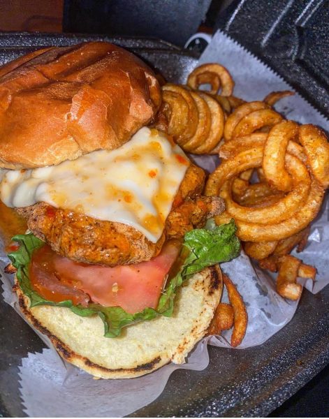 "Fried Salmon Sandwich and Curly Fries – A Perfect Blend of Crispy and Juicy Delights"