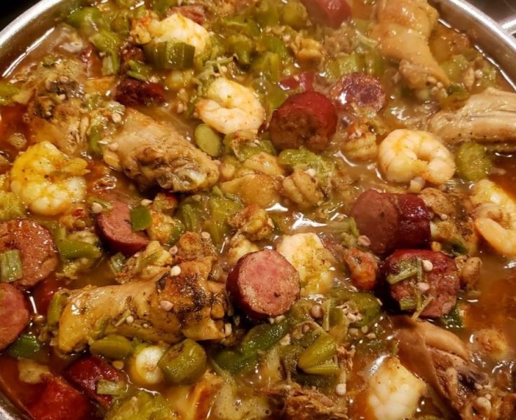 Bowl of okra stew with chicken, shrimp, and crawfish tails, served over rice