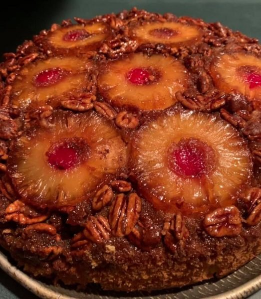 A slice of Upside Down Candied Pecan Pineapple Cake on a plate