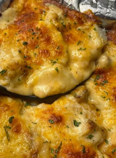 Cheesy scallop potatoes - golden brown, creamy layers of tender potato slices topped with melted cheese.