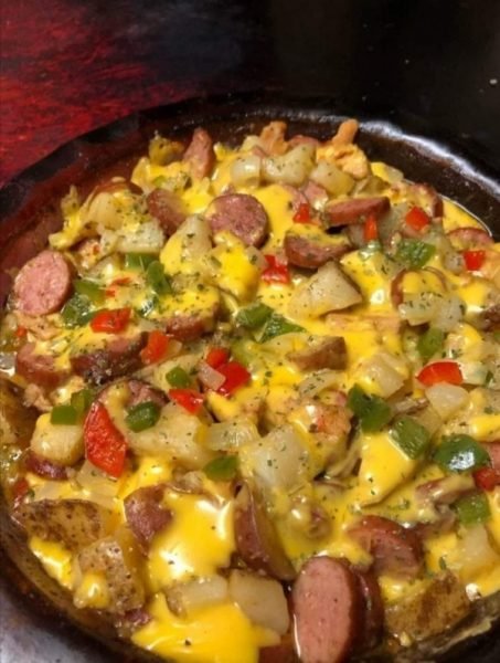 Cheese Potato & Smoked Sausage Casserole image: A close-up view of a hot and bubbling casserole dish filled with cheesy potato and sausage mixture.