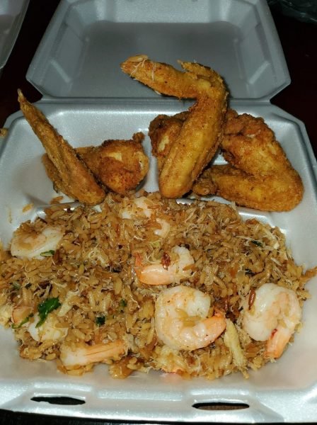 A close-up of a plate of Crab & Shrimp Fried Rice, with succulent crab and shrimp scattered over fluffy fried rice.