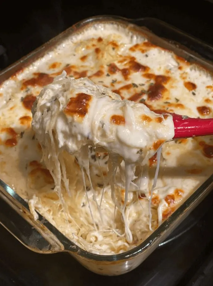 Chicken spaghetti in a creamy tomato sauce with parsley garnish