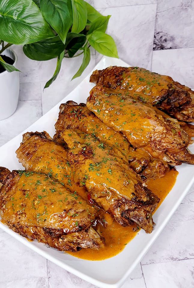 Close-up of a fried turkey wing coated in Buffalo Wild Wings spicy garlic sauce