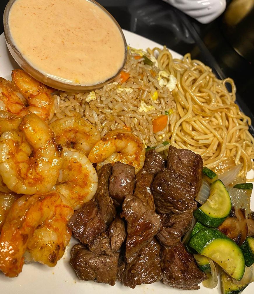 A platter of colorful homemade hibachi with a variety of vegetables and your choice of protein