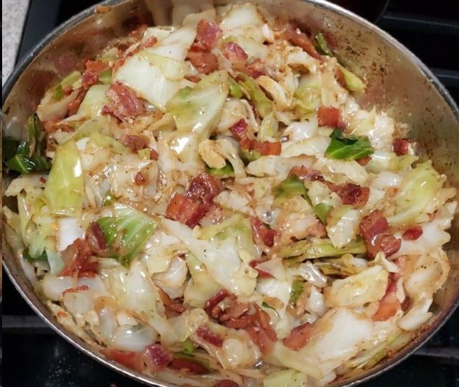 Sizzling bacon crumbles atop a bed of perfectly cooked cabbage in our signature Fried Cabbage recipe.