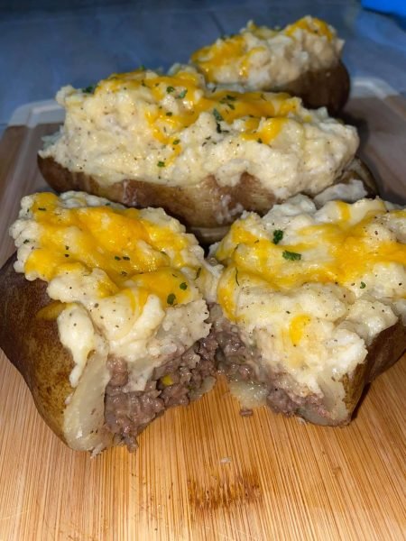 A shepherd's pie filling baked inside a potato, topped with melty cheese and parsley.