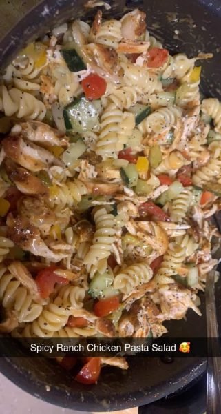 A bowl of Spicy Ranch Chicken Pasta Salad with chopped cilantro and green onions on top