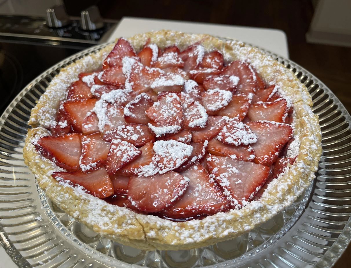 A beautifully arranged Strawberry Tart with a golden crust and juicy strawberries on top, ready to be served on Valentine's Day.