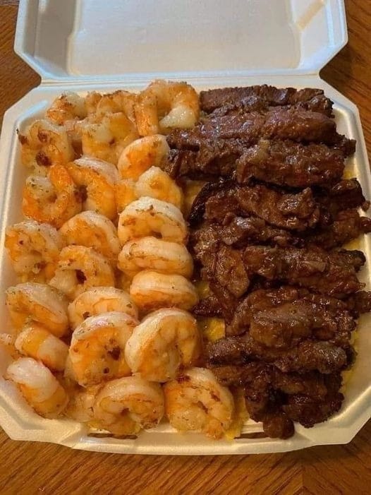 A plate of Cajun Shrimp, Chicken, and Steak Alfredo Pasta