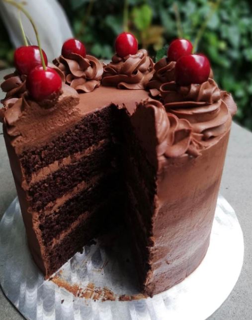 Chocolate Valentine's Cake with Valentine's Day sprinkles and chocolate curls on top.