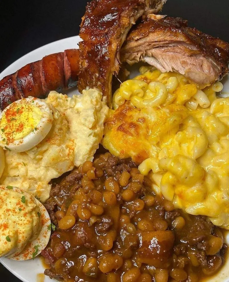 Baby Back Ribs with Mac and Cheese, Baked Beans, and Mashed Potatoes on a Plate