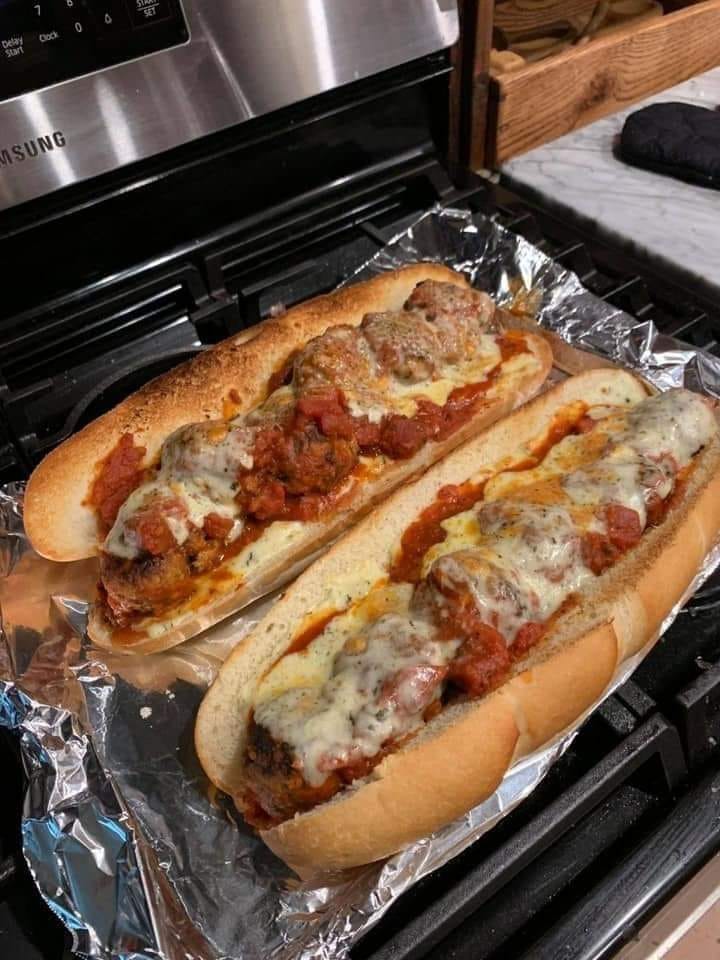 "Homemade Meatball Sub - Golden roll filled with flavorful homemade meatballs, melted cheese, and saucy goodness."