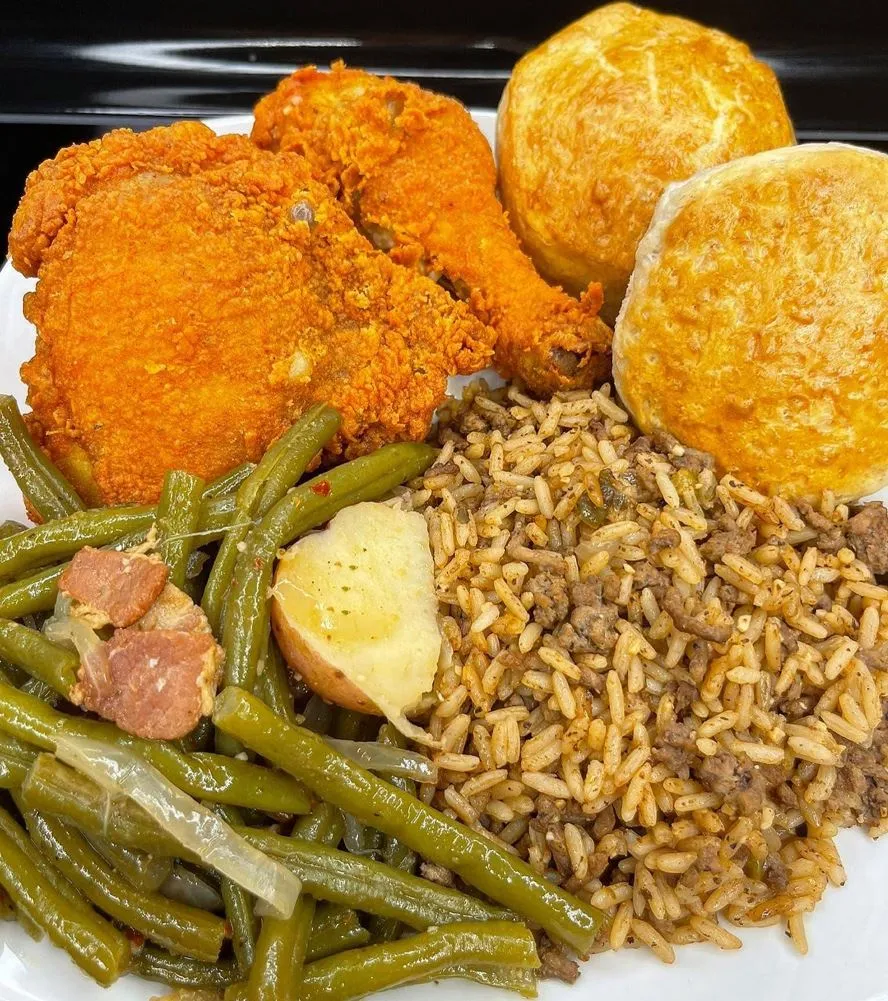 Crispy chicken fry with creole seasoning and jambalaya rice on a plate