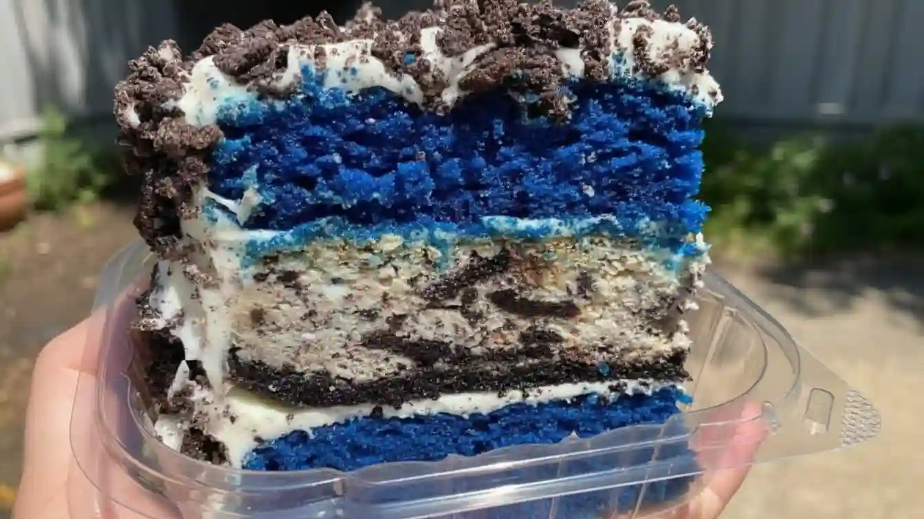 Closeup of a Blue Velvet Oreo Cheesecake Cake with Oreo crumbs on top