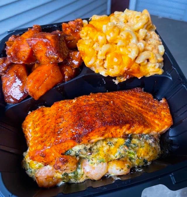 A plate of Stuffed Salmon, Candied Yams, and Mac & Cheese, a mouthwatering culinary delight