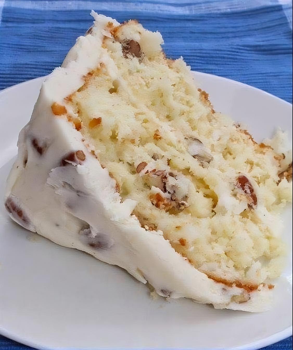 "Decadent Italian Cream Cake made with a mix, layers of coconut and pecans, topped with cream cheese frosting"