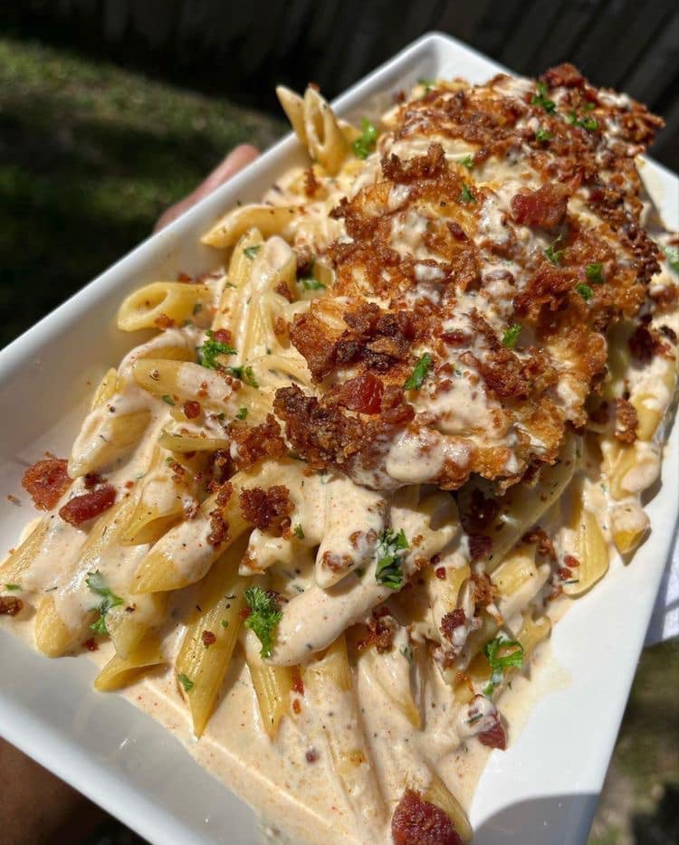 "Chicken Bacon Ranch Alfredo: A delicious plate of homemade pasta topped with grilled chicken, crispy bacon, and creamy Alfredo sauce."