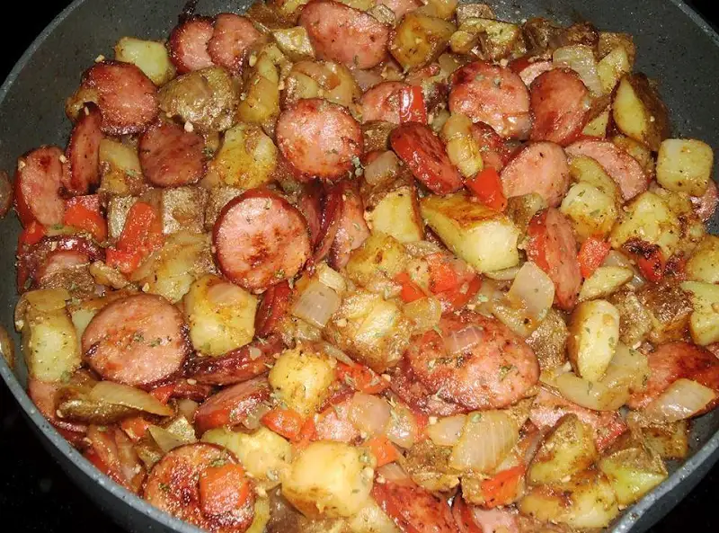 "Skillet Potatoes Recipe: A medley of russet potatoes, smoked sausage, and vegetables in a sizzling pan, showcasing culinary excellence."