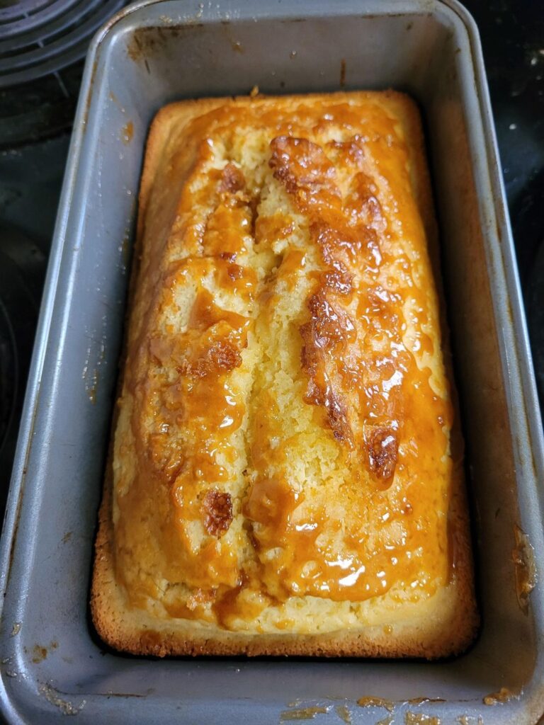 Irresistible Lemon Cake To Die For on a 9x13 baking pan, showcasing golden perfection and tangy glaze.