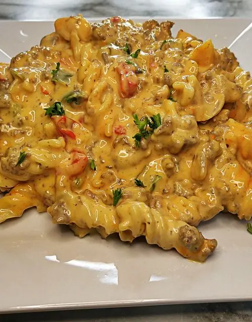 Image of a bowl of Rotel Pasta topped with grated cheese and parsley